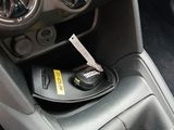 a car dashboard with a remote control in the center of it