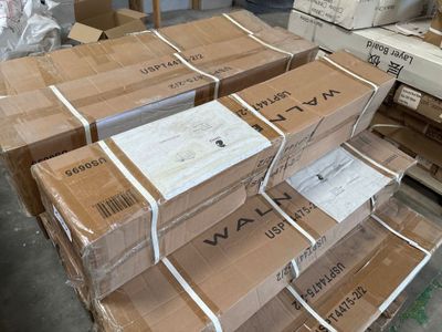 many boxes stacked on top of each other in a warehouse