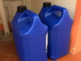 two blue jugs sitting on the floor next to each other