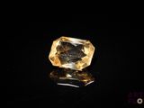 a yellow diamond on a black surface