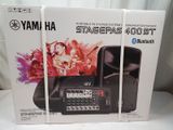 a box with two speakers and a remote in it