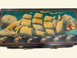 a box with a painting of a ship on it
