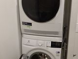an image of a washer and dryer in a small room