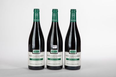 trois bouteilles de vin posées sur une table blanche
