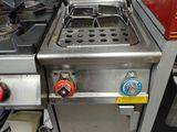 une petite cuisine équipée d'une cuisinière et d'une plaque de cuisson