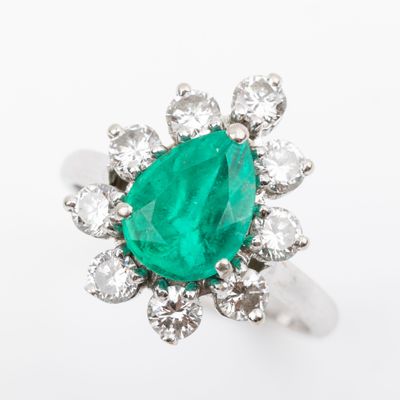 an emerald and diamond cluster ring