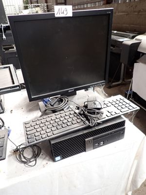 a computer sitting on a table with a keyboard and mouse