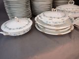 a lot of plates and bowls on a table