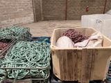 a crate of rope and a bin of rope on the ground
