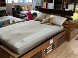 un lit en bois sur lequel est posé un matelas