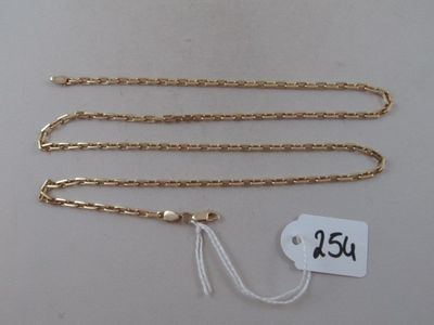 a close up of a gold chain with a price tag on it
