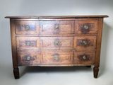 an old wooden chest of drawers with many drawers on top