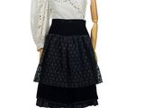 a mannequin wearing a black and white dress on a mannequin stand