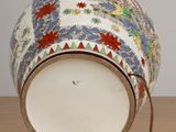 a vase that has been decorated with flowers and leaves