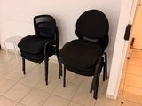 two black chairs sitting next to each other in a room