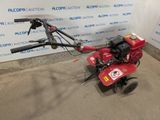 an image of a small tiller in a garage