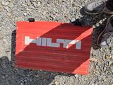 a person standing next to a red box with the word filt on it