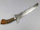 a knife with a wooden handle on a white surface
