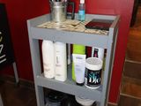 a shelf that has a lot of hair products on it