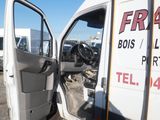 a white van with the door open in a parking lot