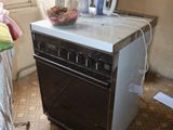 an image of a kitchen with an oven and ironing board