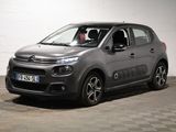 La Citroën grise est garée sur un sol à damier dans un garage