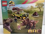 the box is open to show the contents of the lego jurassic park set
