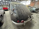 an old car that is sitting in a garage