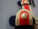 a close up of a red and gold hat with a gold lion on it