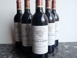several bottles of wine are lined up on a table