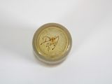 a close up of a small bottle with a bird on it