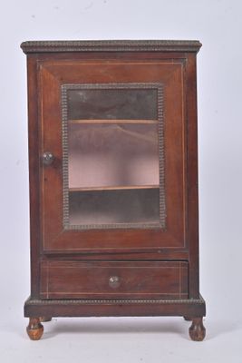 a small wooden cabinet with a glass door on it
