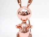 the rabbit is sitting on its hind legs with its legs crossed