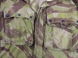 a close up of a camouflage jacket with buttons on it
