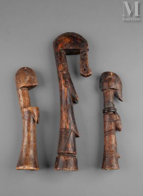 three pieces of wood carved to look like people