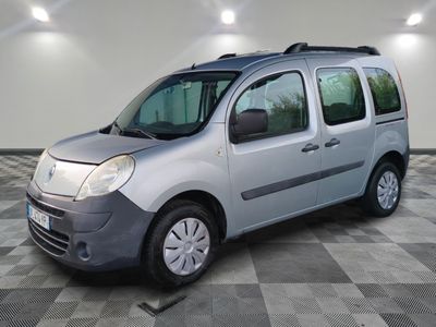 a picture of a small silver van parked in a garage