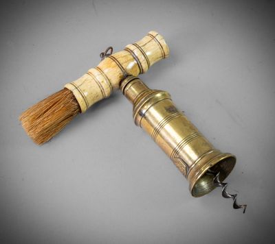 an old brass bell with a wooden handle and a wooden handle