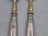 two forks and a spoon sitting on a table