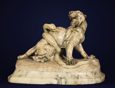 marble sculpture of a lion and a lioness on a rock
