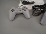 two video game controllers sitting next to each other on a table