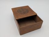 a small wooden box with a lid on a white surface