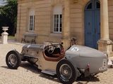 a vintage car parked in front of a large building