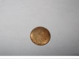 a gold coin sitting on top of a white surface