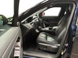 the interior of a car with the door open and the driver ' s seat down