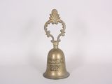 brass bell with ornate design on a white background