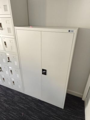 a white cabinet in the corner of a room