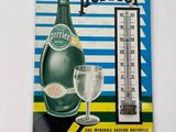 une image représentant un thermomètre à côté d'une bouteille de bière