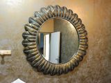 a mirror on the wall above a sink in a bathroom