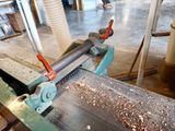 a machine that is working on a piece of wood