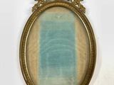 an old picture frame with a blue and yellow painting in it